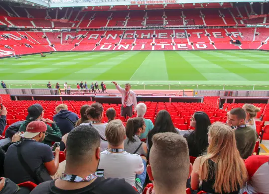 Auf Klassenfahrt mit HEROLÉ: Eine Schulklasse auf der Zuschauertribüne im Old Trafford Stadion in Manchester