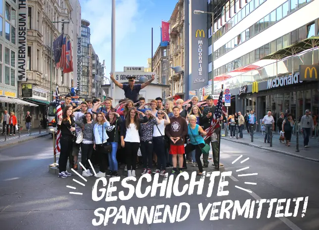 Schülergruppe bei Ihrer Geschichtsreise am Checkpoint Charlie in Berlin Auf Klassenfahrt mit HEROLÉ: Nutzen Sie unsere vielen Angebote für eine spannende Geschichtsreise