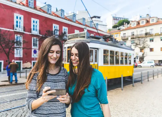 Auf Klassenfahrt mit HEROLÉ: Zwei Mädchen vor einer Straßenbahn in Lissabon